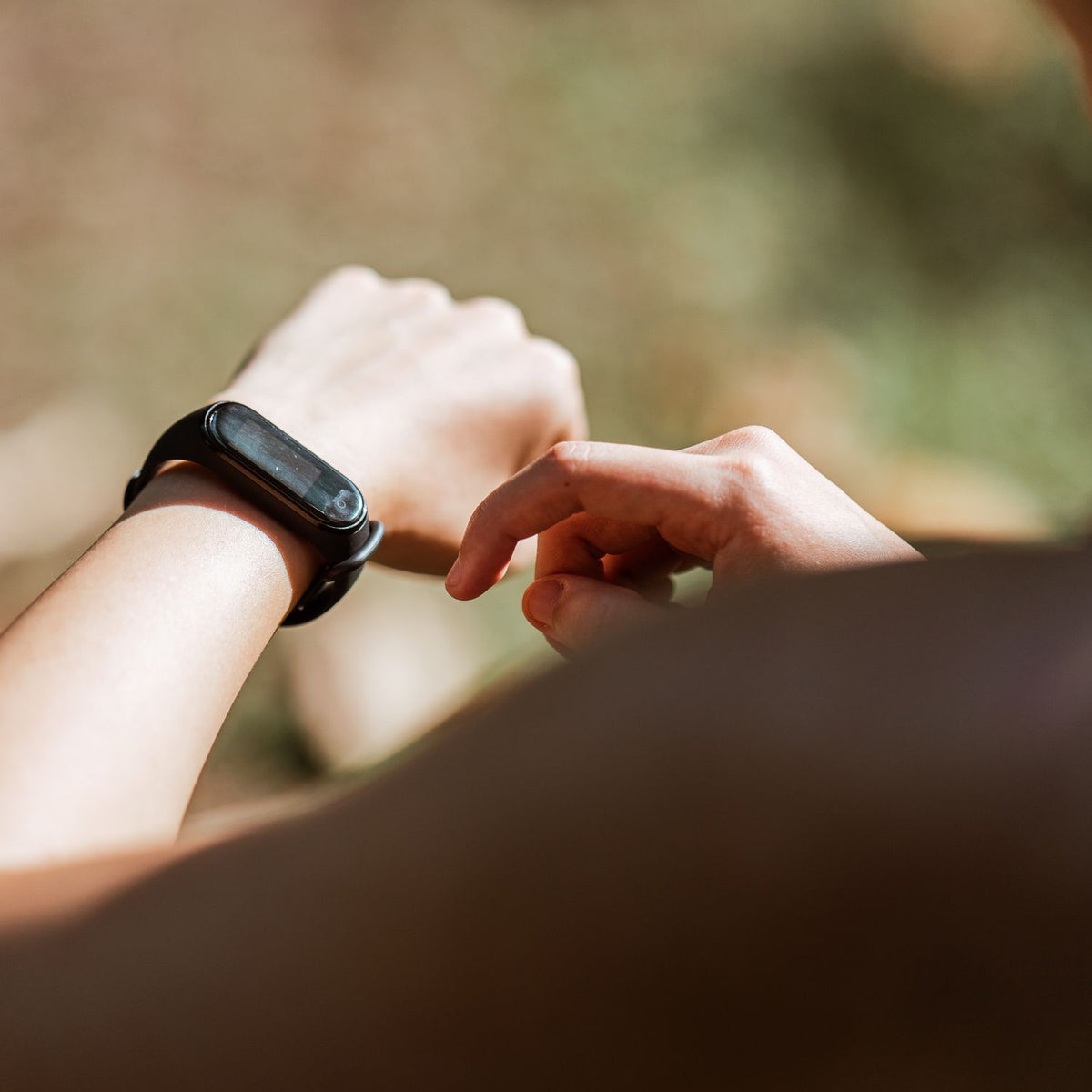 Woman checking her fitness band while training