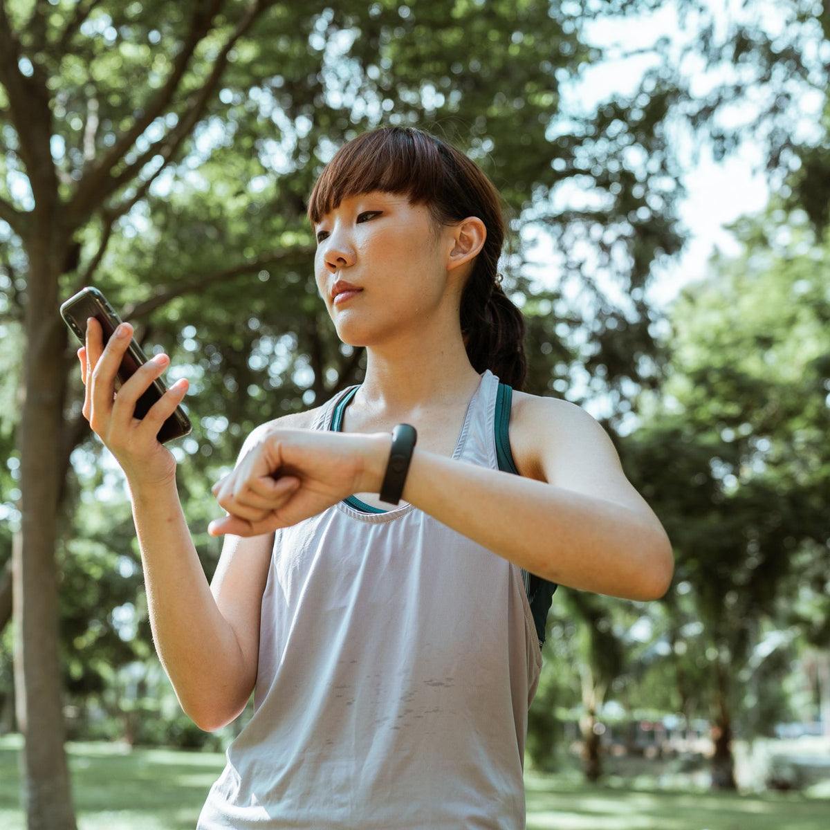 Runner using a phone and fitness band while training