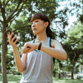 Runner using a phone and fitness band while training