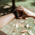 Black fitness band worn in an autumn park