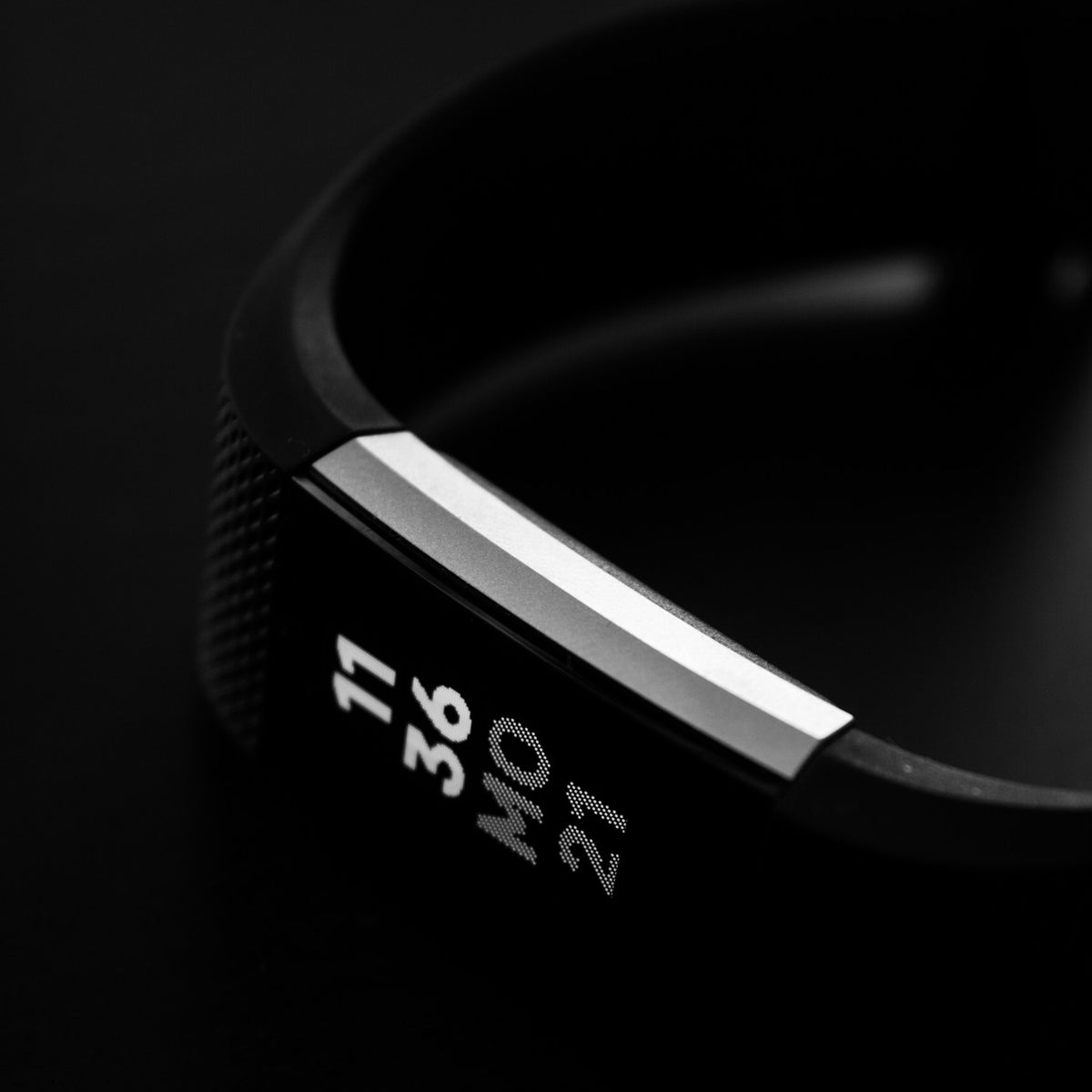 Fitness band showing the time on a wrist