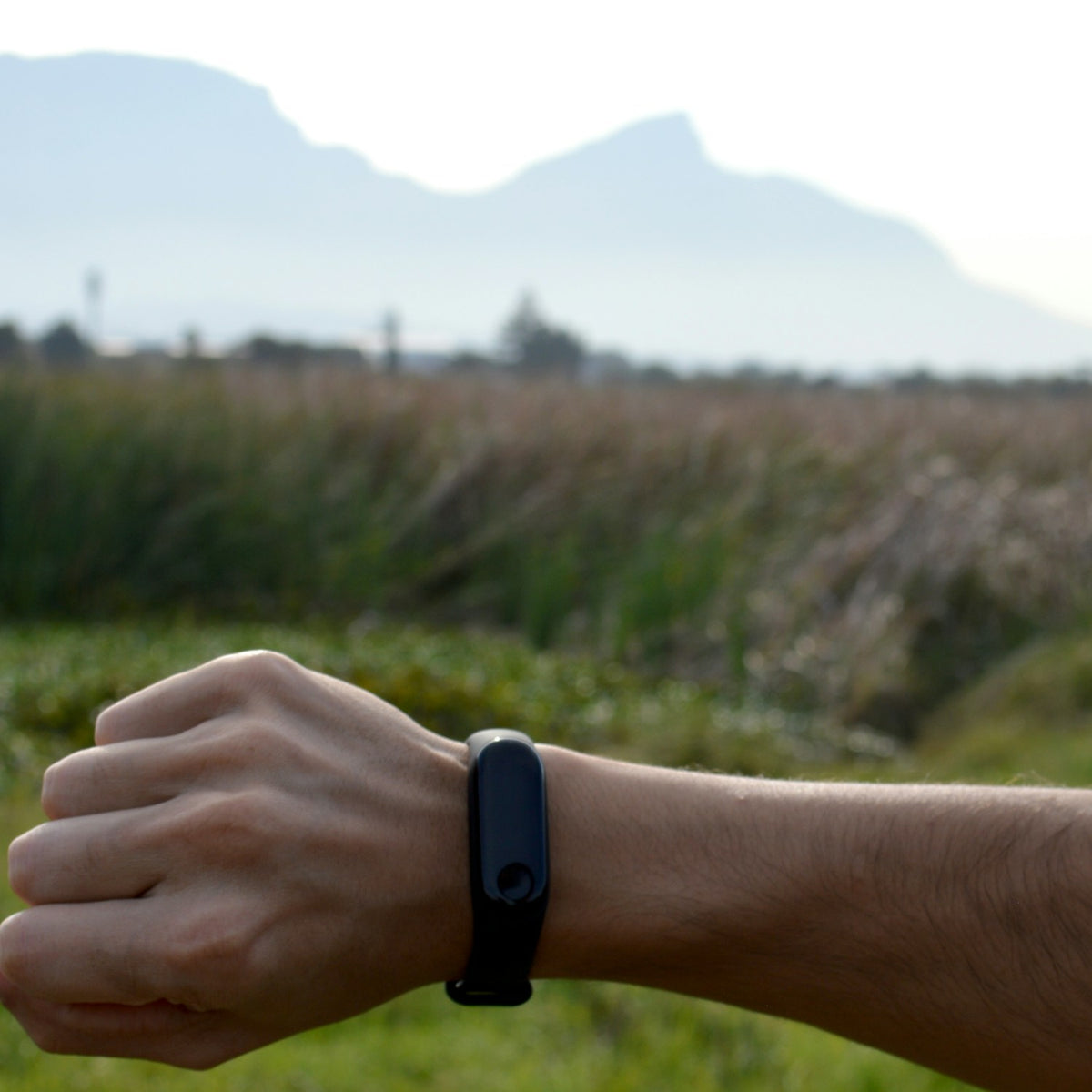 Man checking his fitness band outdoors