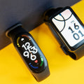 Xiaomi fitness bands on a yellow and grey background